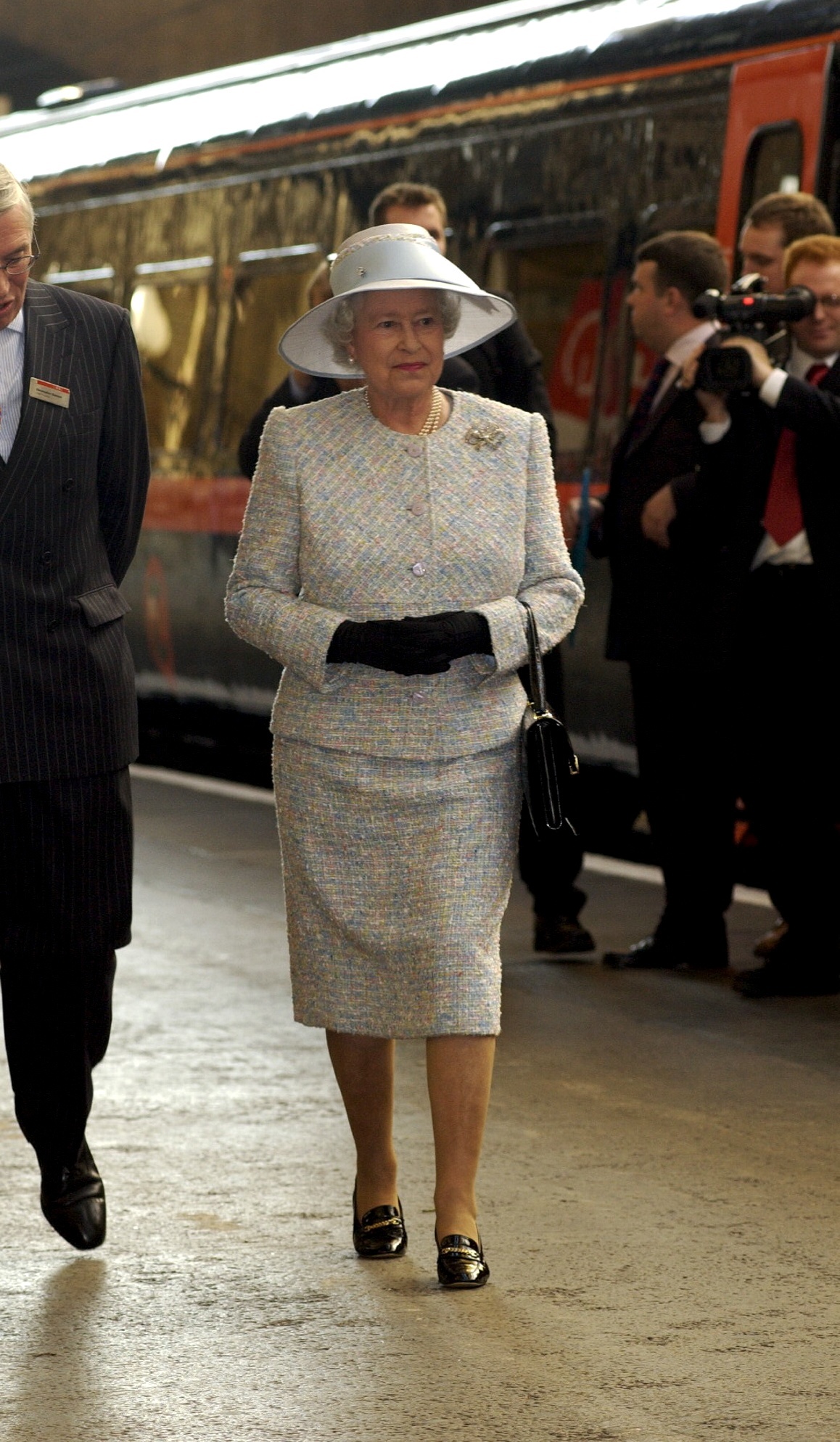 HRH Queen Elizabeth talks to rail staff at King's Cross Station.